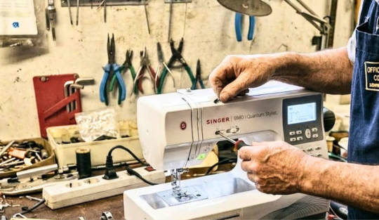 Tecnico controlla una macchina da cucire aperta sul banco del laboratorio di Correggio